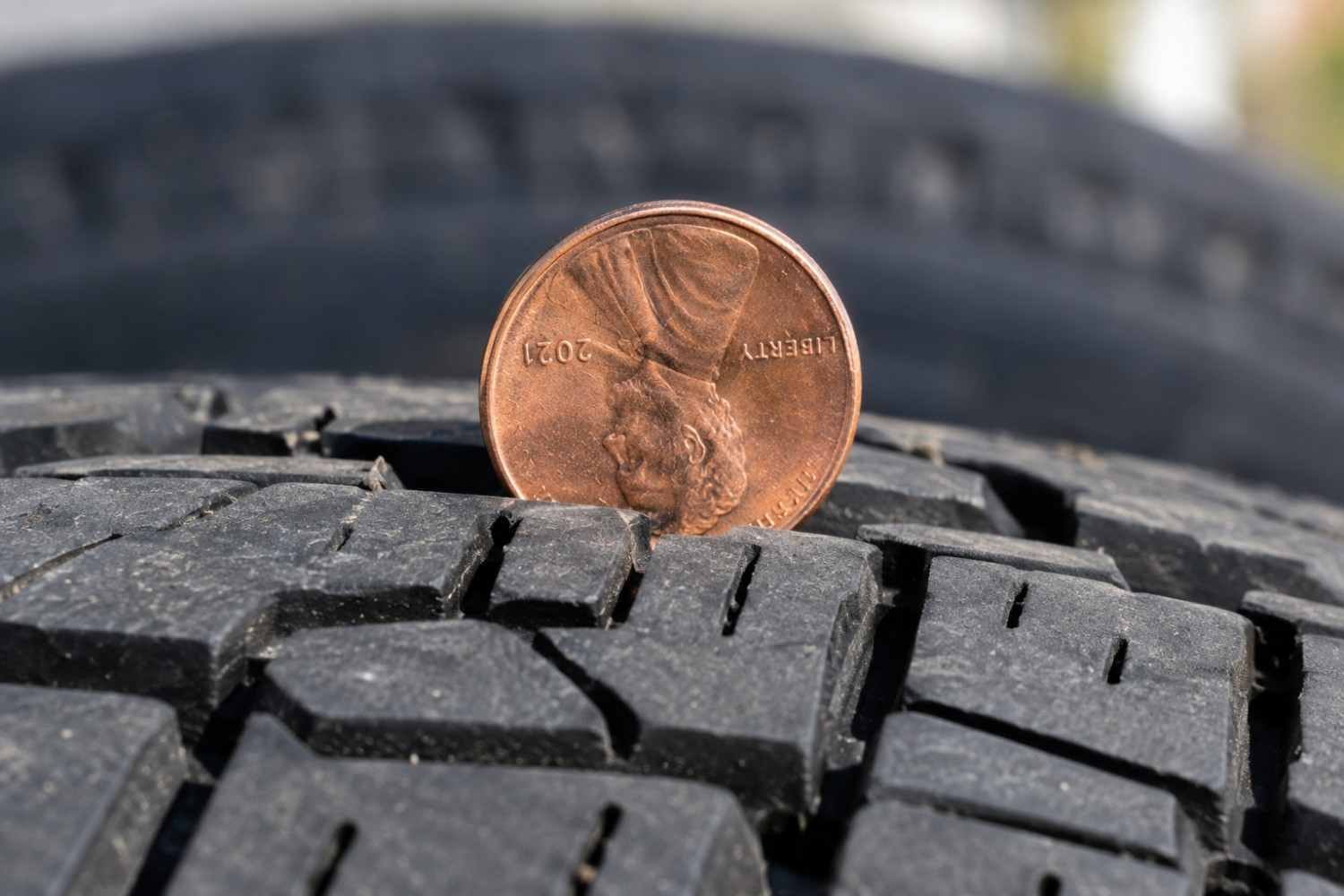 Penny test for checking tire tread depth on a car tire